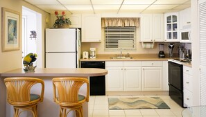 kitchen includes dishwasher, full size stove, microwave and seating