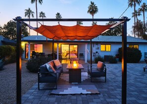 Stunning private yard with sparkling pool (pool heat available), sun loungers, cabana, fire pit, covered patio, and outdoor dining.