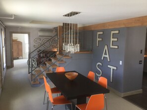 Dining room with first floor bedroom beyond and stairs to 2nd floor. 
