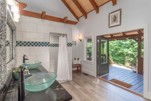 Spa like bathroom with walk-in shower and bathrobes.