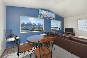 Spacious living room and dining area with views of the harbor and bay!