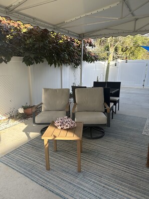 Swivel Rocker Chairs Under a Large Canopy/Awning.