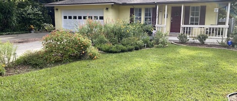 Front of the house with the butterfly gardens.