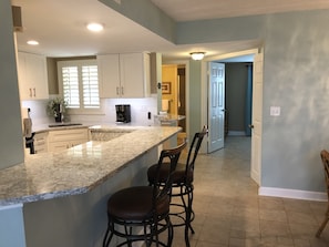 Updated kitchen with quartz countertops and stainless appliances,