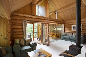 Living space with pine dining table area. Double doors out to large deck. 