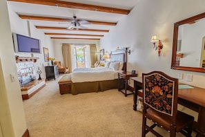 View of living area, with desk and gas fireplace.