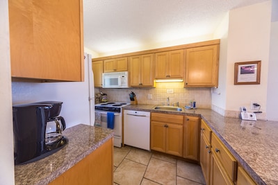 Fully equipped kitchen with new dishwasher, stove, sink and microwave. 