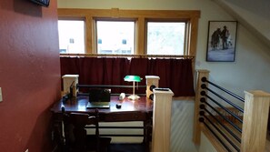 Workspace with desk and lamp, Wi-Fi router.  Stairway to the ground floor.  