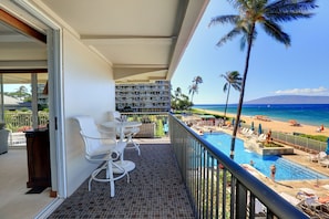 The lanai off of living area with two patio tables.