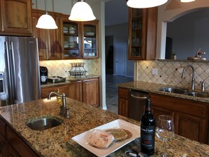 Spacious granite and stainless steel kitchen.