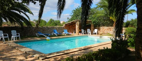 Private pool with lots of seating and shade.