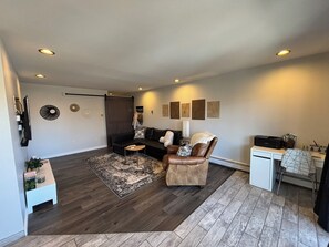Living area from dining area. Barn door closed.