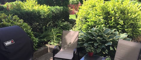 BBQ and chairs  in a very private corner of the courtyard 