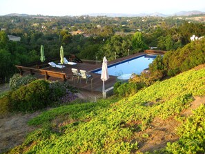 Backyard pool, redwood deck, chaise lounges, dining table, & spectacular views.