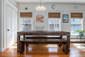 A handmade farmhouse-style table sits in the middle of the dining room