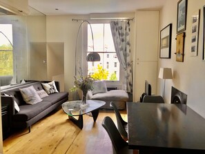 The open plan living room and dining table, shot from the kitchen.