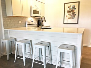 All new renovated kitchen.  Full-sized appliances.  Breakfast bar seats 4.