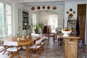 Kitchen, seating area, and entryway. Last windows are in living room.