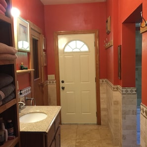 Master bathroom view of  sink. Sauna attaches at left.