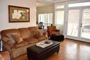 The comfortable living room has French doors to the balcony with a Square view.