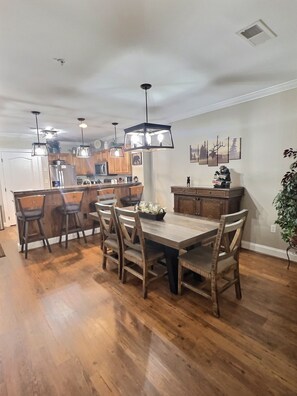 Picture of dining room tables (seats 6) and the kitchen