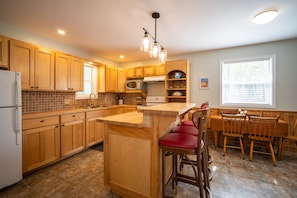 Kitchen with island eating area and table and chairs

