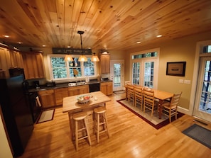 An open kitchen with family-friendly dining makes meal time a joyous occasion.