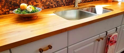 The Copper Penny back splash and butcher block count tops.