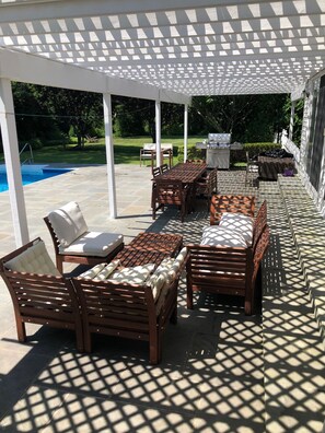 Outdoor lounge under beautiful veranda facing the pool. Two big tables (12+)