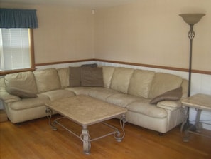 Large leather sleeper sofa in living room.