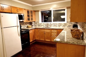Brand new kitchen with stove, oven, dishwasher, fridge and microwave.