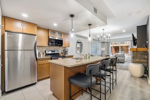 Kitchen with 3 chairs at eating bar