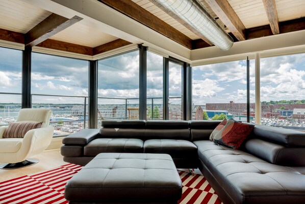 Large living area with expansive views of harbor and city.