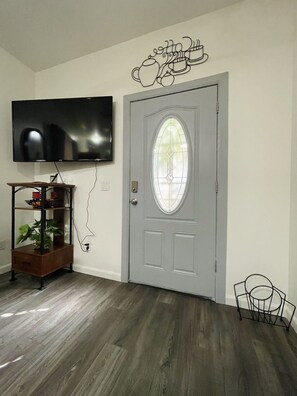 Entrance door from the inside. Samsung tv with firestick for guest to stream.