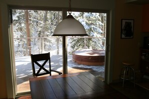 view through the sliding door to the deck and the spa