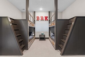 Walk-out basement bunk area. Doubles on bottom, twins on top.