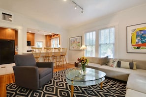 Great open concept living room with natural light and original Austin art.