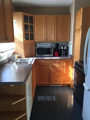 Full kitchen. Features a share cabinet with non perishable items.  