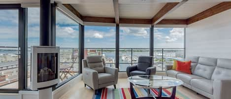 Living area with expansive views of harbor and city.