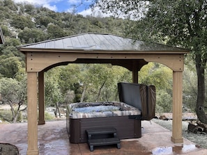 Hot tub seating 8 people overlooking the waterfall