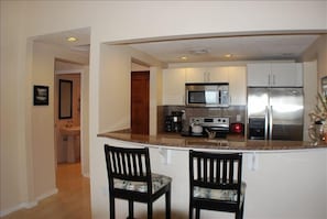 Full kitchen with stainless steel appliances.  Half bath to the left.