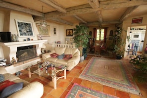 lounge and dining room with beamed ceiling.