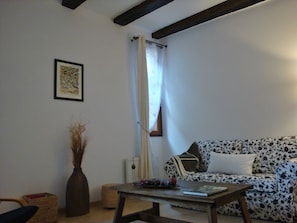 living room with original ceiling beams
