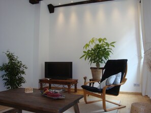 Living room with sofa and arm chair with view of church square