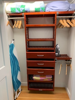 closets with iron and board, beach towels and storage.