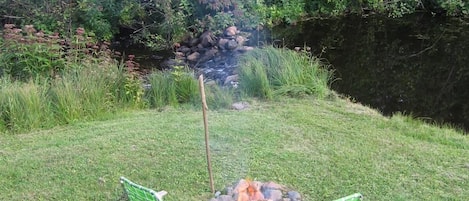 The firepit and our tiny meadow on the river.