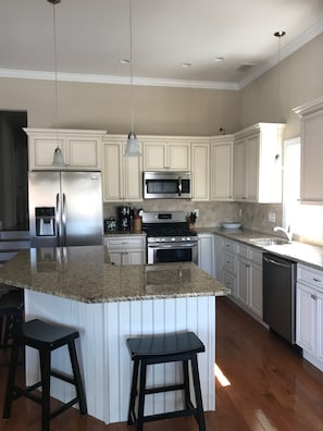 Beautiful, bright well-equipped kitchen opens into family room. 