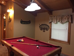 Pool table in loft game room. 