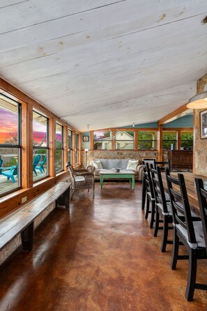 Windows and views and comfy indoor/outdoor gathering areas!