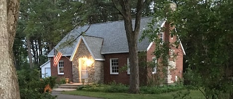 Front of cottage showing section of circle drive.  